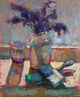 Still life painting with purple flowers in a white vase, brushes and a glass, illuminated by the sunlight