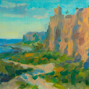 Majestic cliffs bathed in the golden hues of a sunset by the sea