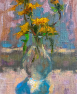 Sunlit dandelions gracefully arranged in a glass vase