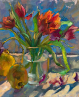 Sunlight streaming over a beautiful composition of tulips and quince fruit